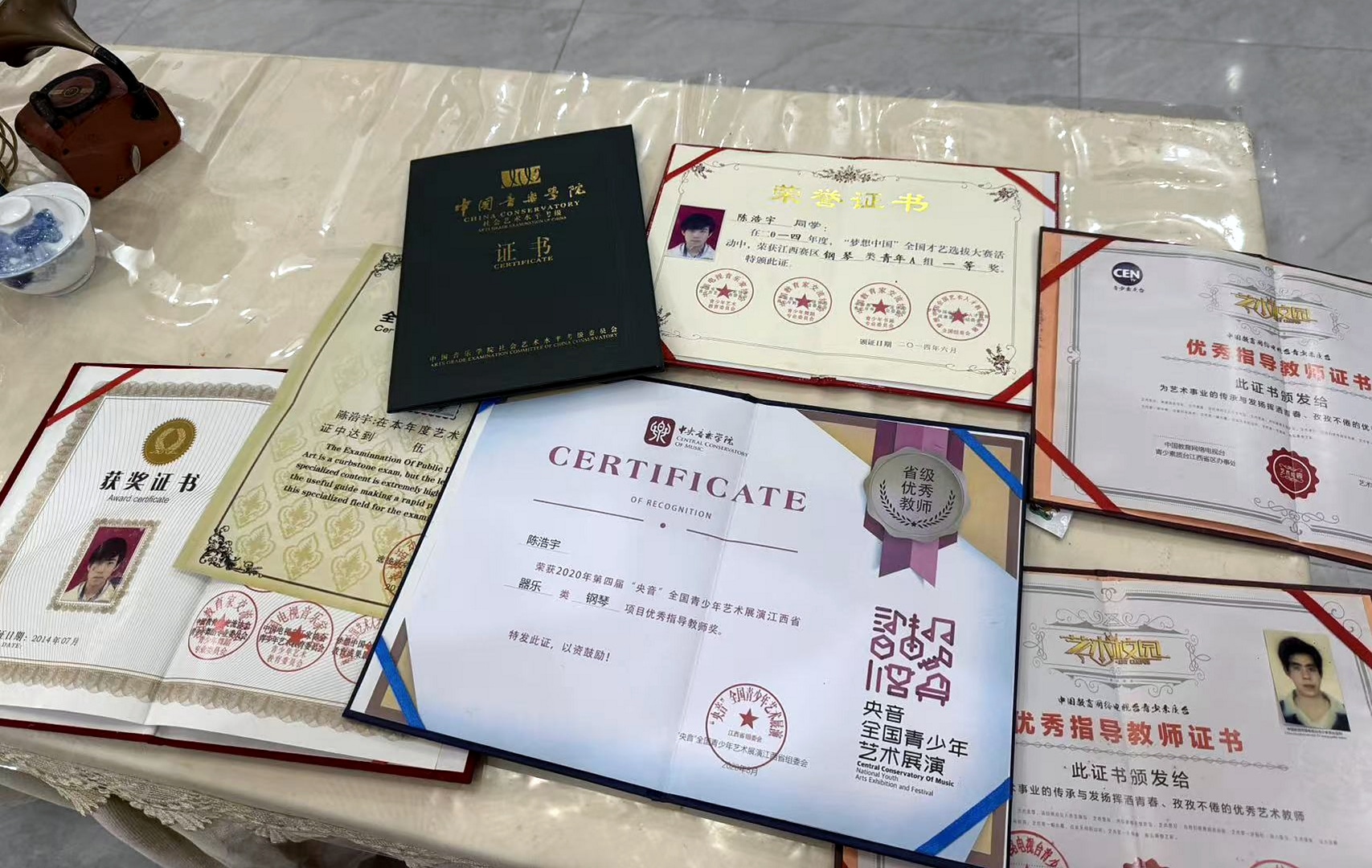 桌面铺放的陈浩宇教师认可与获奖证书真实记录